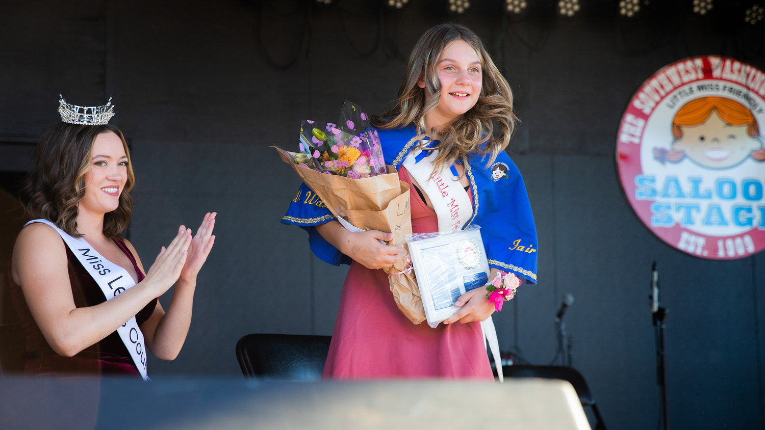 MaKayla Maynard smiles after being presented with a plaque and flowers Tuesday afternoon on the Saloon Stage at the Southwest Washington Fairgrounds in Centralia.