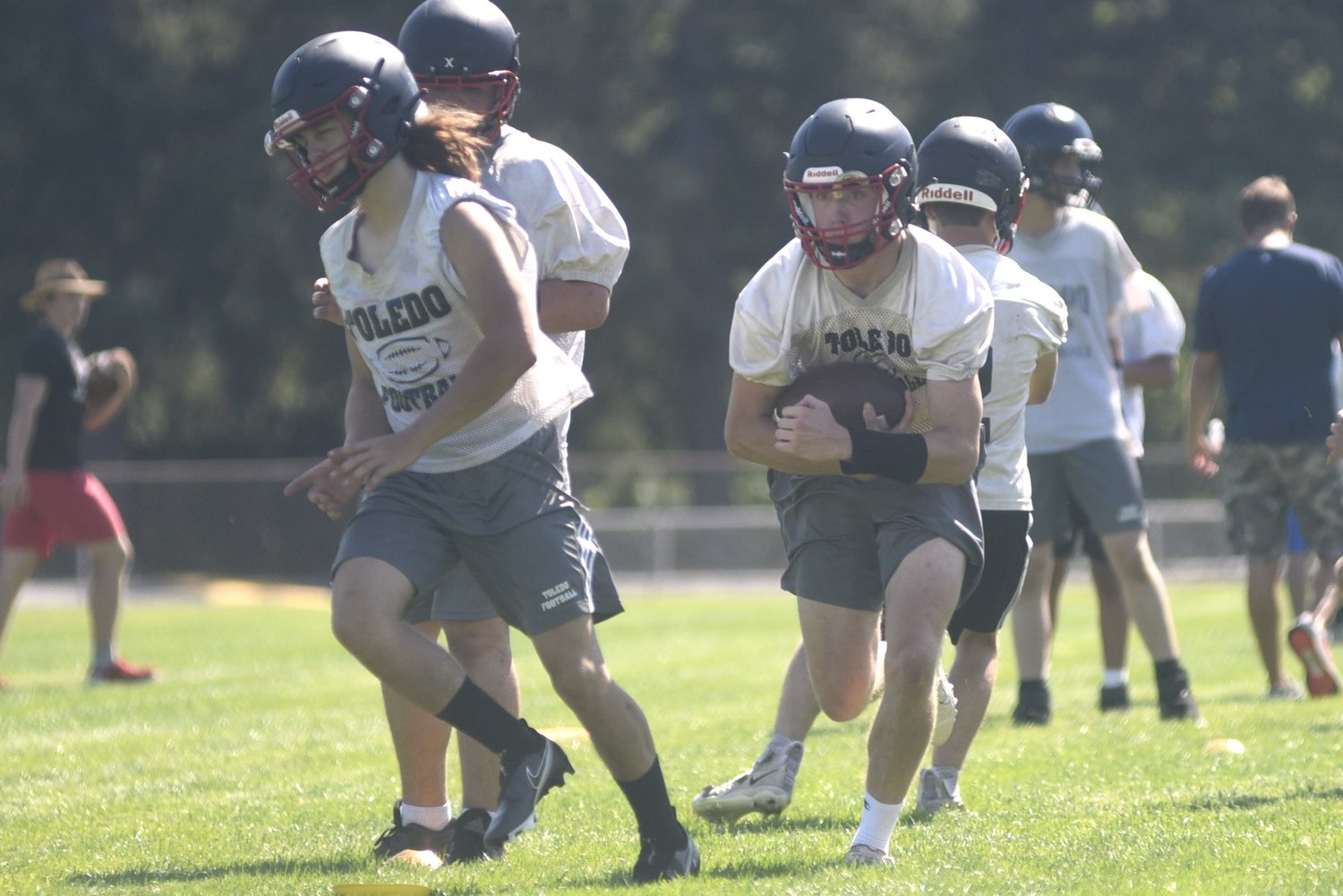 Geoffrey Glass follows Zane Raney upfield at a practice on Aug. 17 at Ted Hippi Field.