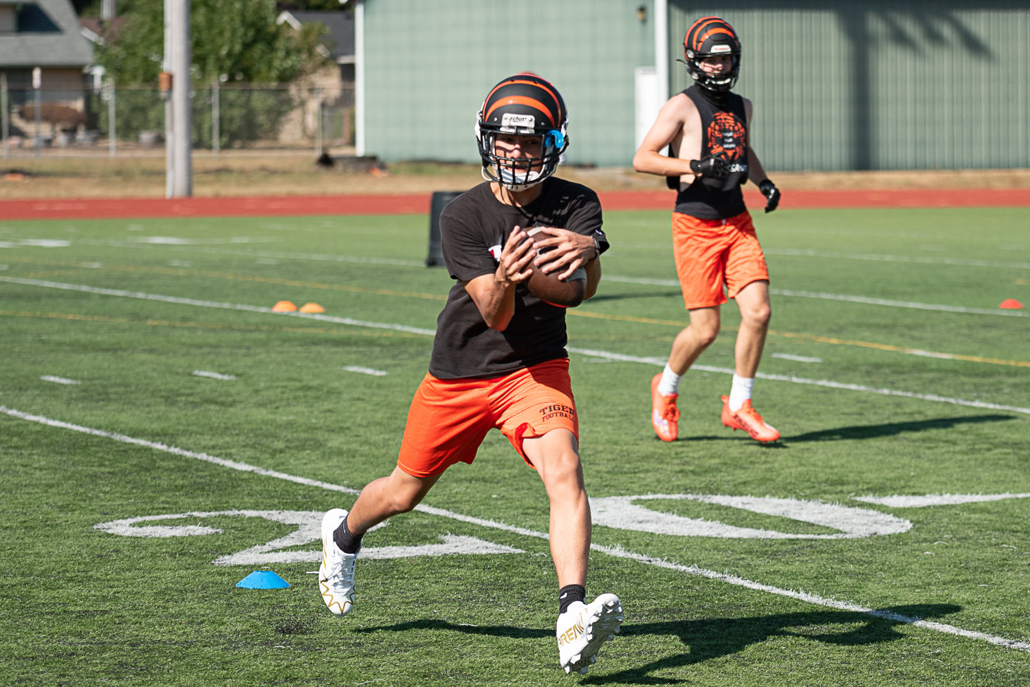 A Centralia player hauls in a pass during a drill during the first day of fall camp Aug. 17 at Tiger Stadium.