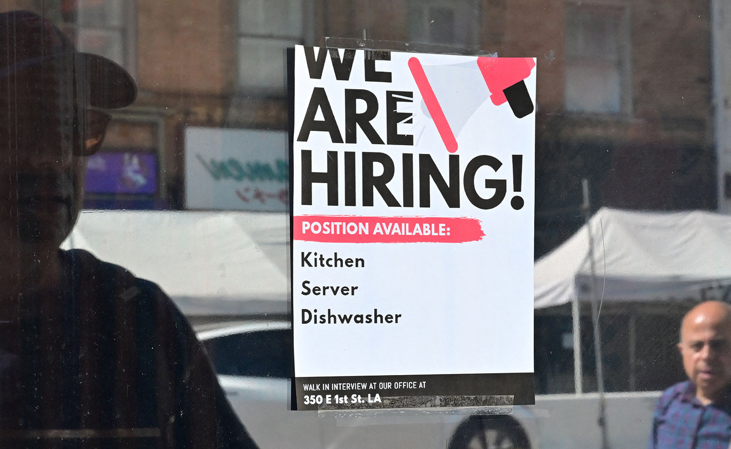 A "We Are Hiring" sign is posted in front of a restaurant in Los Angeles, California on Aug. 17, 2022. (Frederic J. Brown/AFP via Getty Images/TNS)