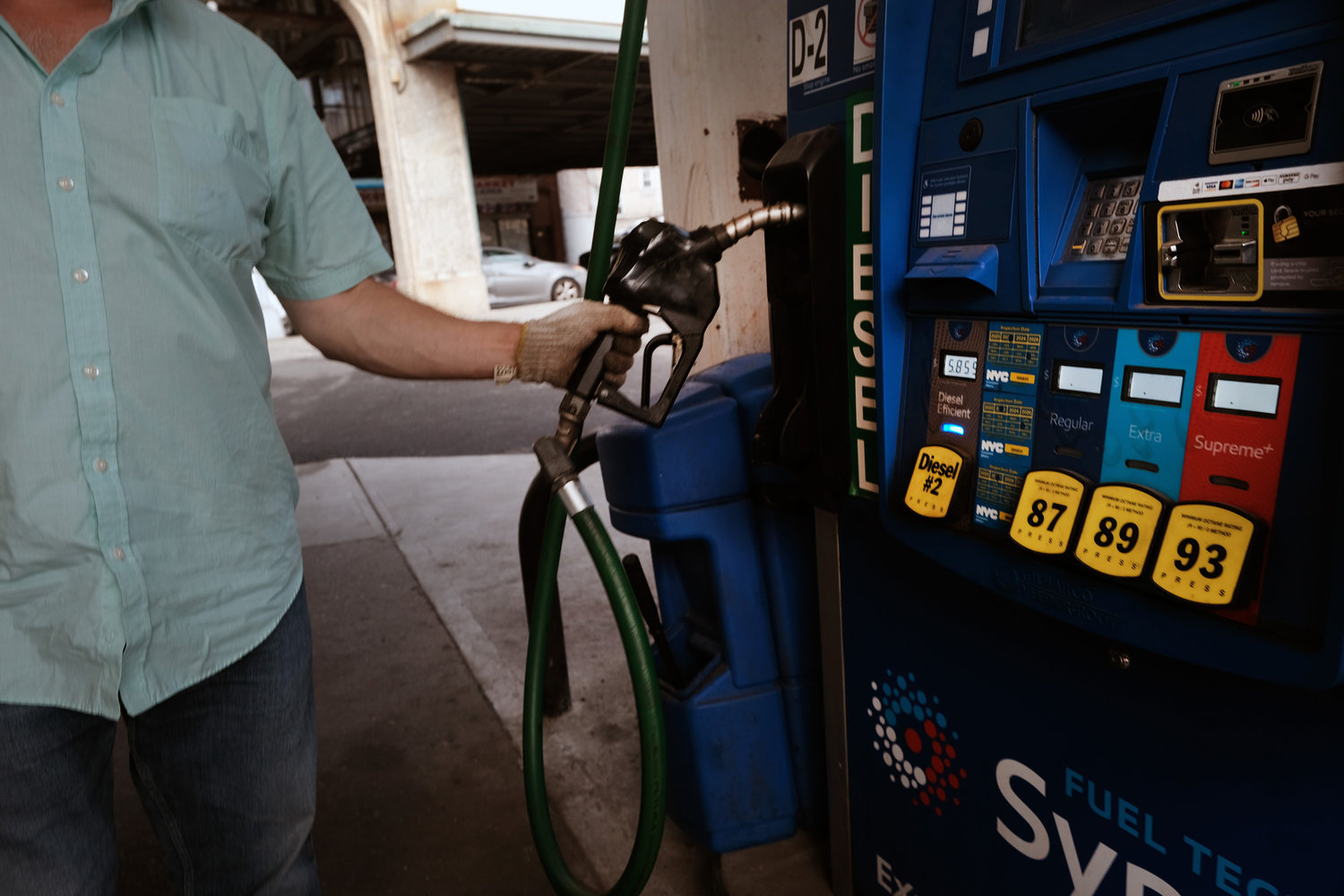 A bus driver fills up at a gas station in Brooklyn on Aug. 11, 2022, in New York.  (Spencer Platt/Getty Images/TNS)