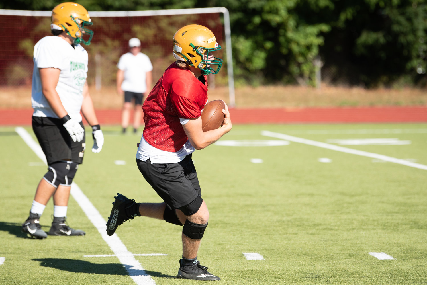 Quarterback Alex Overbay takes it on a carry during Tumwaters' Aug. 22 practice.