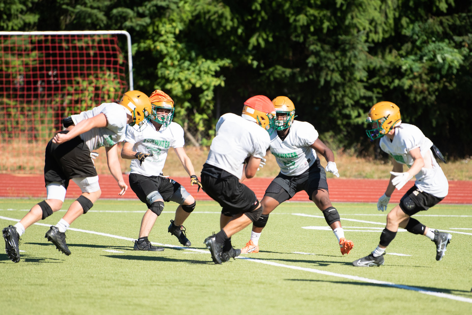 Thunderbirds swarm to the ballcarrier during their practice on Aug. 22 at Sid Otton Field.