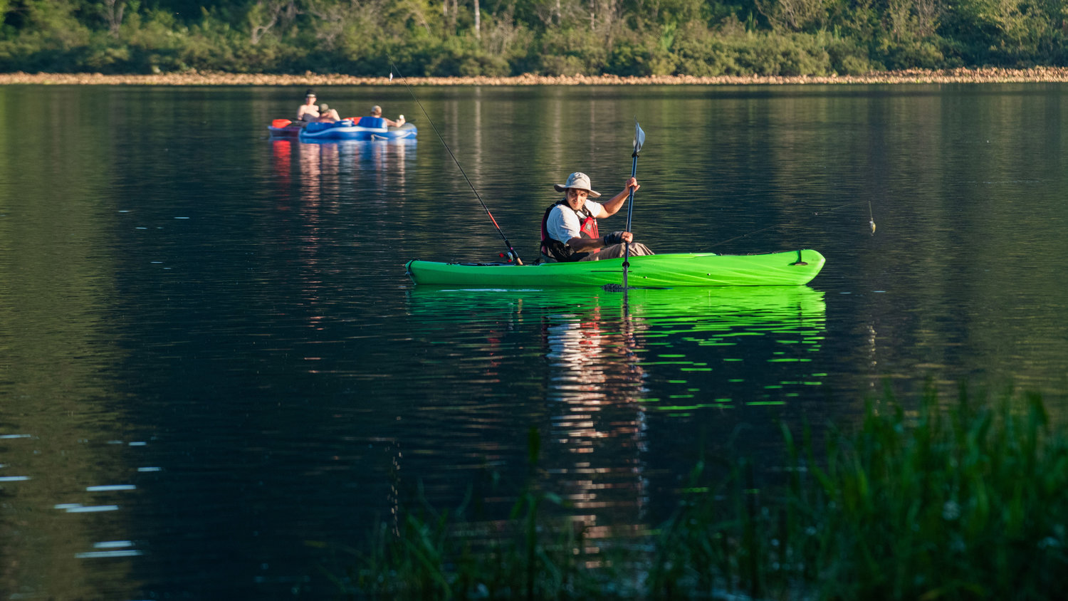 Fishing lures dangle as a kayaker paddles across Deep Lake at Millersylvania State Park.
