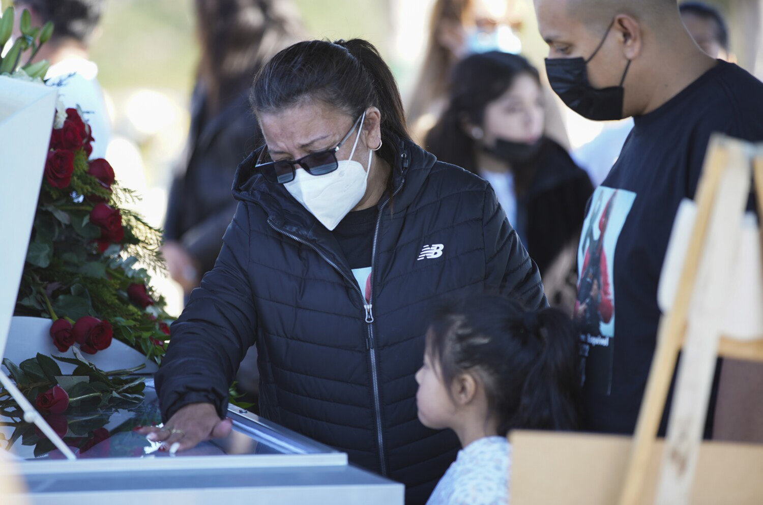 Coverage of Tijuana photojournalist Margarito Martinez Esquivel's funeral. Elena Frausto, wife of Margarito, says goodbye before the casket is laid to rest at Cemetery Santa Gema on Jan. 21, 2022, in Tijuana, Baja California. (Alejandro Tamayo/San Diego Union-Tribune/TNS)
