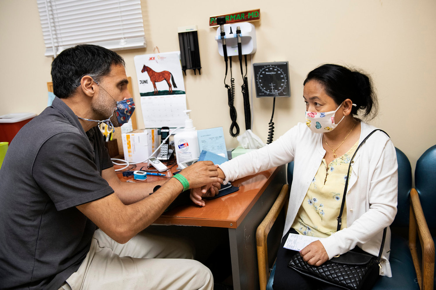 Dr. P.J. Parmar treats a patient at Mango House in Aurora, Colorado. Patient advocates are suing the government over a Trump-era rule focusing on out-of-pocket health care costs. (Ross Taylor/KHN/TNS)