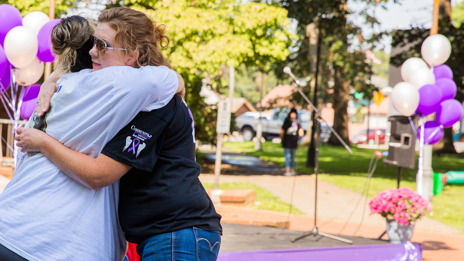Crystal Aguilar receives an embrace at George Washington Park in Centralia during an overdose awareness event on Wednesday.