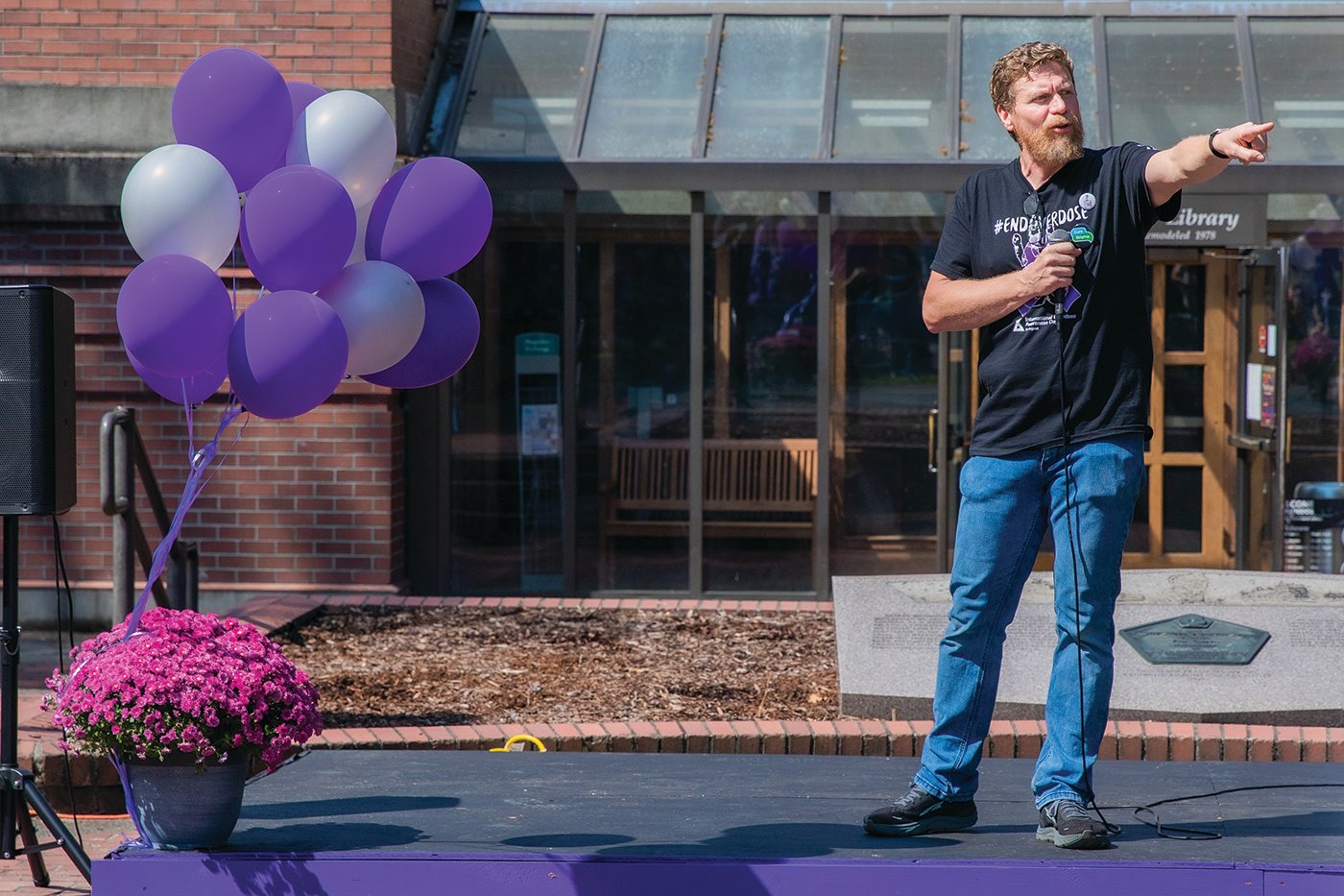 Gather Church Pastor Cole Meckle points and names resource groups in attendance at George Washington Park in Centralia during an overdose awareness event on Wednesday.