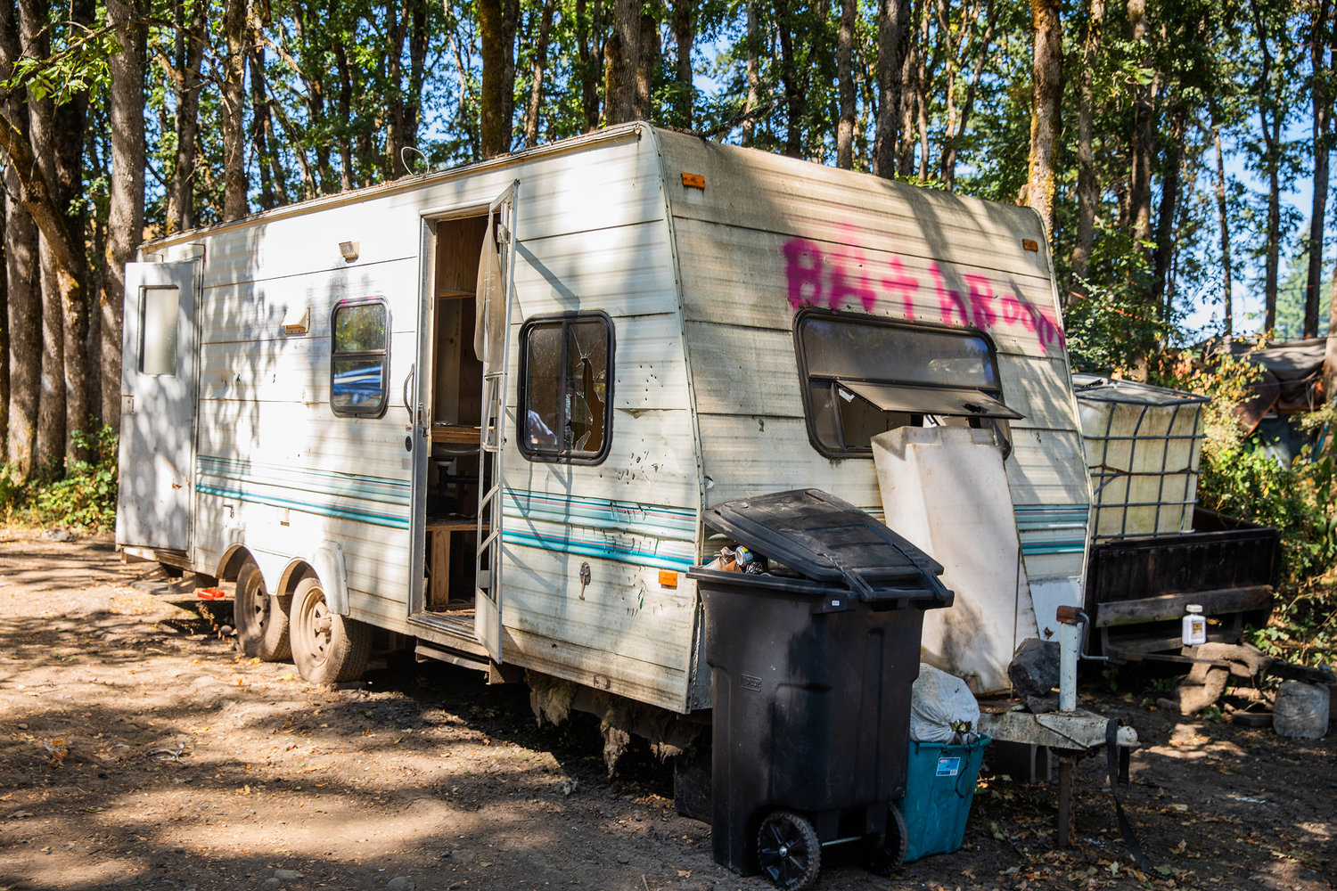 A dilapidated trailer reads “Bathroom” in spray paint at a homeless encampment at the end of Eckerson Road in Centralia earlier this year.