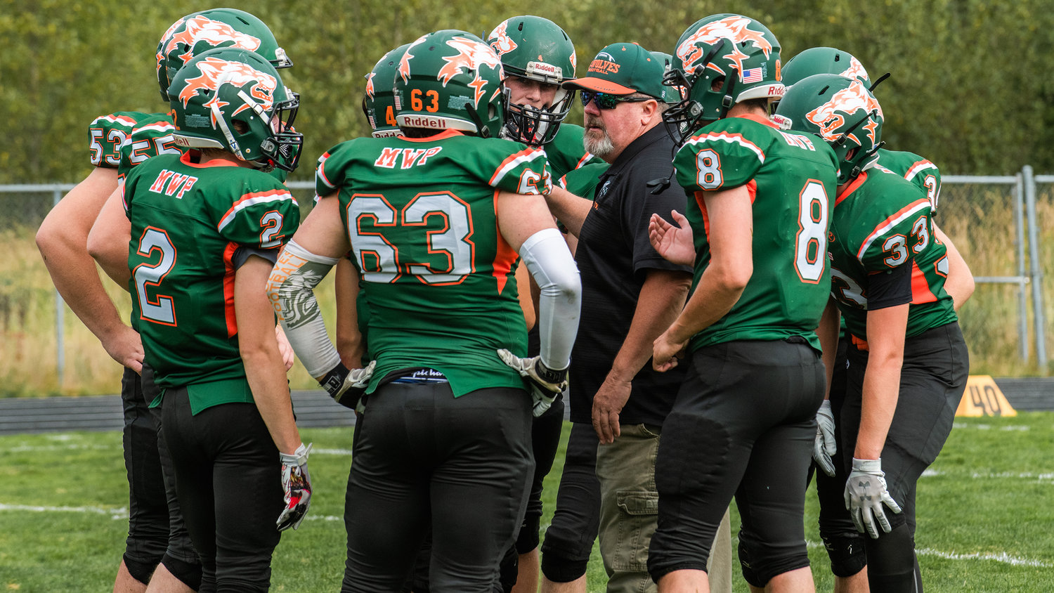 Morton-White Pass Head Coach Lee Metcalf talks to players in a huddle during a game Saturday afternoon in Morton.