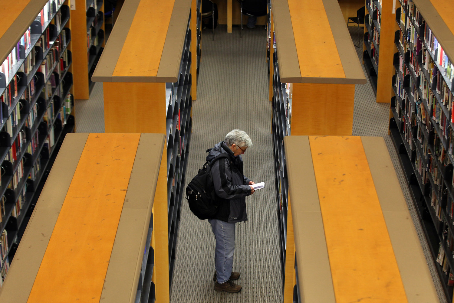 A library patron looks at a book at the main branch of the San Francisco Public Library on Jan. 11, 2011, in San Francisco. Librarians and their legislative allies in several states are pushing publishers of electronic books to lower their prices and ease licensing terms. (Justin Sullivan/Getty Images/TNS)