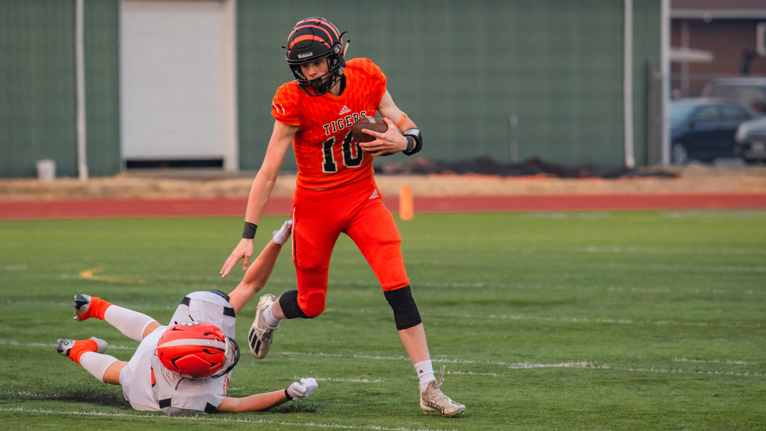Landen Jenkins, quarterback for the Centralia Tigers, successfully avoids a tackle by a Battle Ground Tigers defender in a home game Friday night.