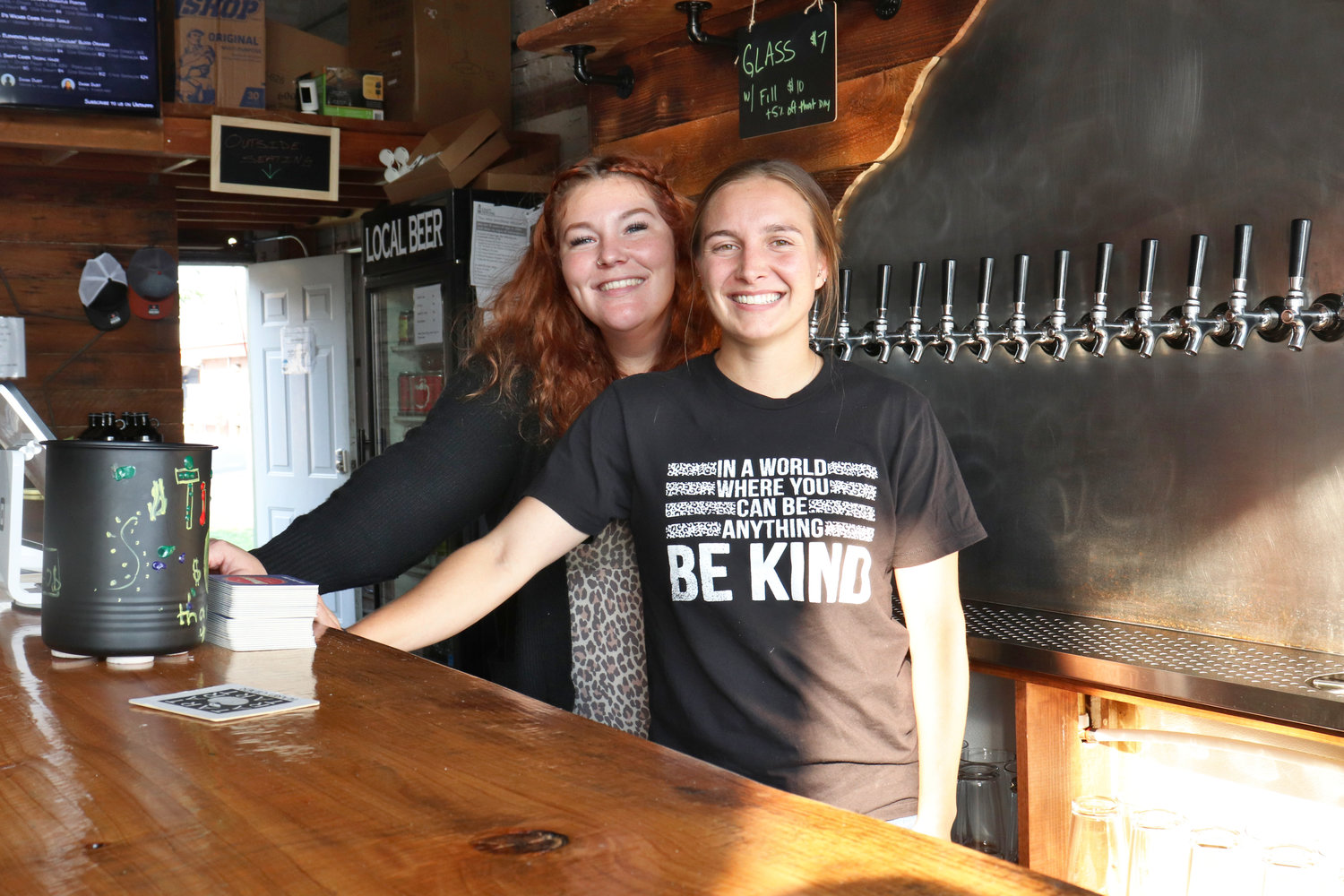 Tumac Taproom employees Grace Hamre and Mackenzie Olson smile behind the bar at Tumac Taproom in Napavine on Friday.