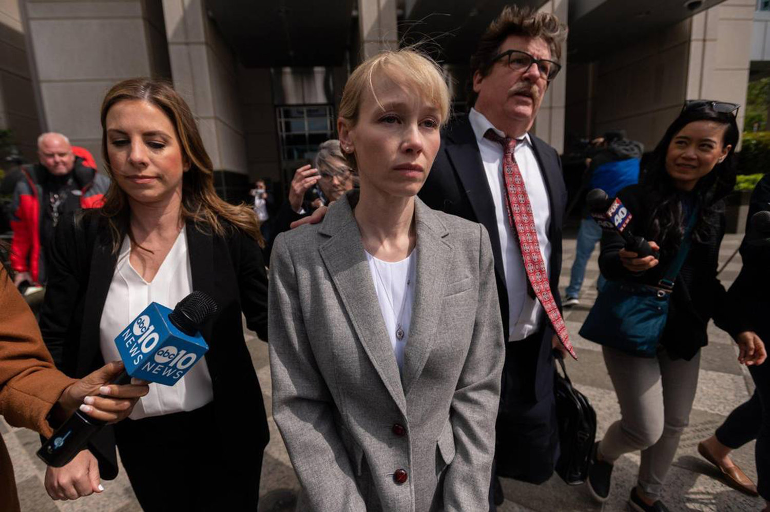 Sherri Papini, center, leaves with attorney William Portanova after her arraignment at the Robert T. Matsui U.S. Courthouse in Sacramento, California, on April 13, 2022. She was charged with faking her own kidnapping in 2016. (Paul Kitagaki Jr./The Sacramento Bee/TNS)