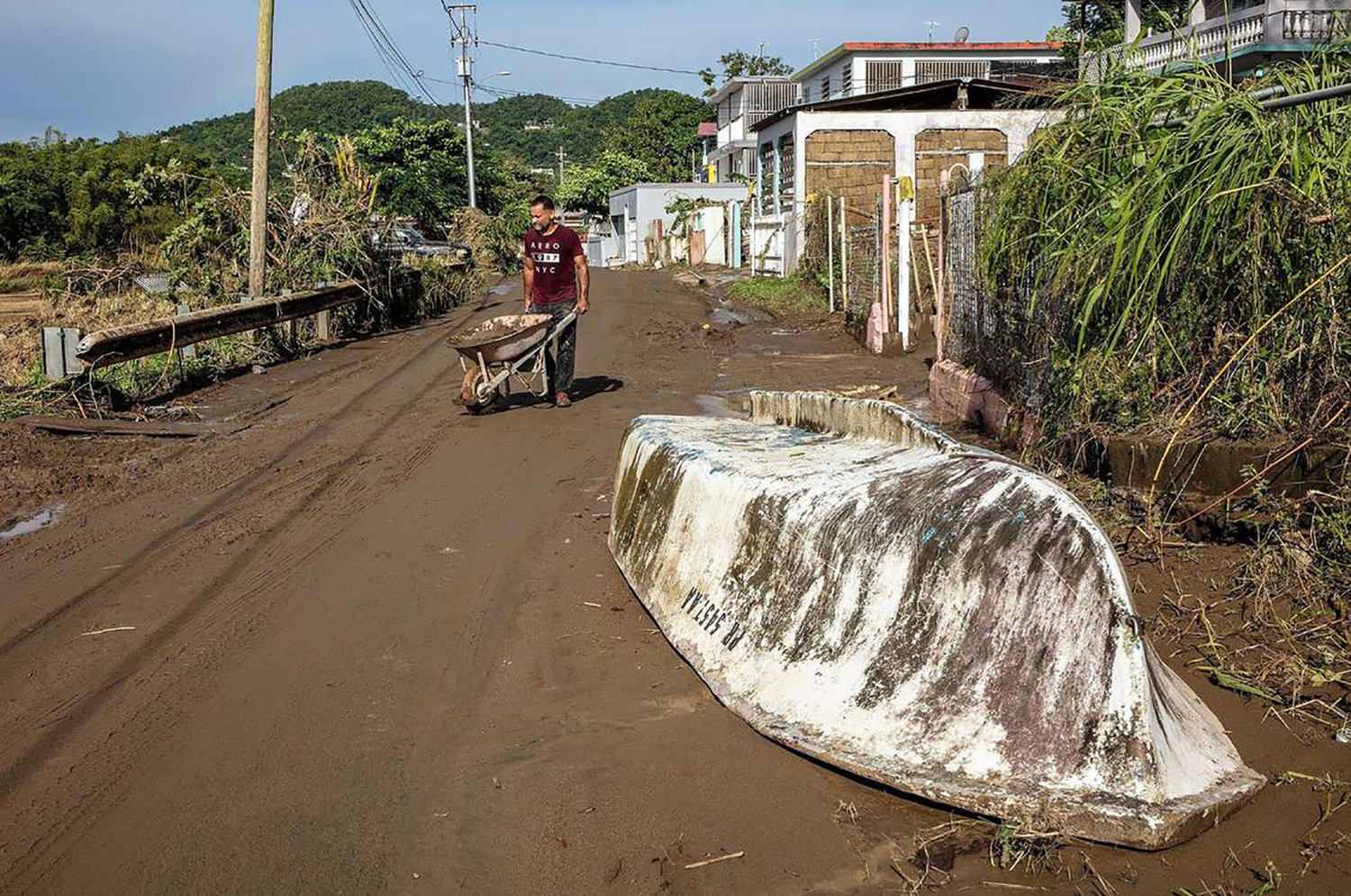 Samuel Santiago removes mud from the front of his house in the San Jose de Toa Baja neighborhood on Tuesday, Sept. 20, 2022, amid flooding after Hurricane Fiona made landfall in Puerto Rico on Sept. 18. (Pedro Portal/El Nuevo Herald/TNS)