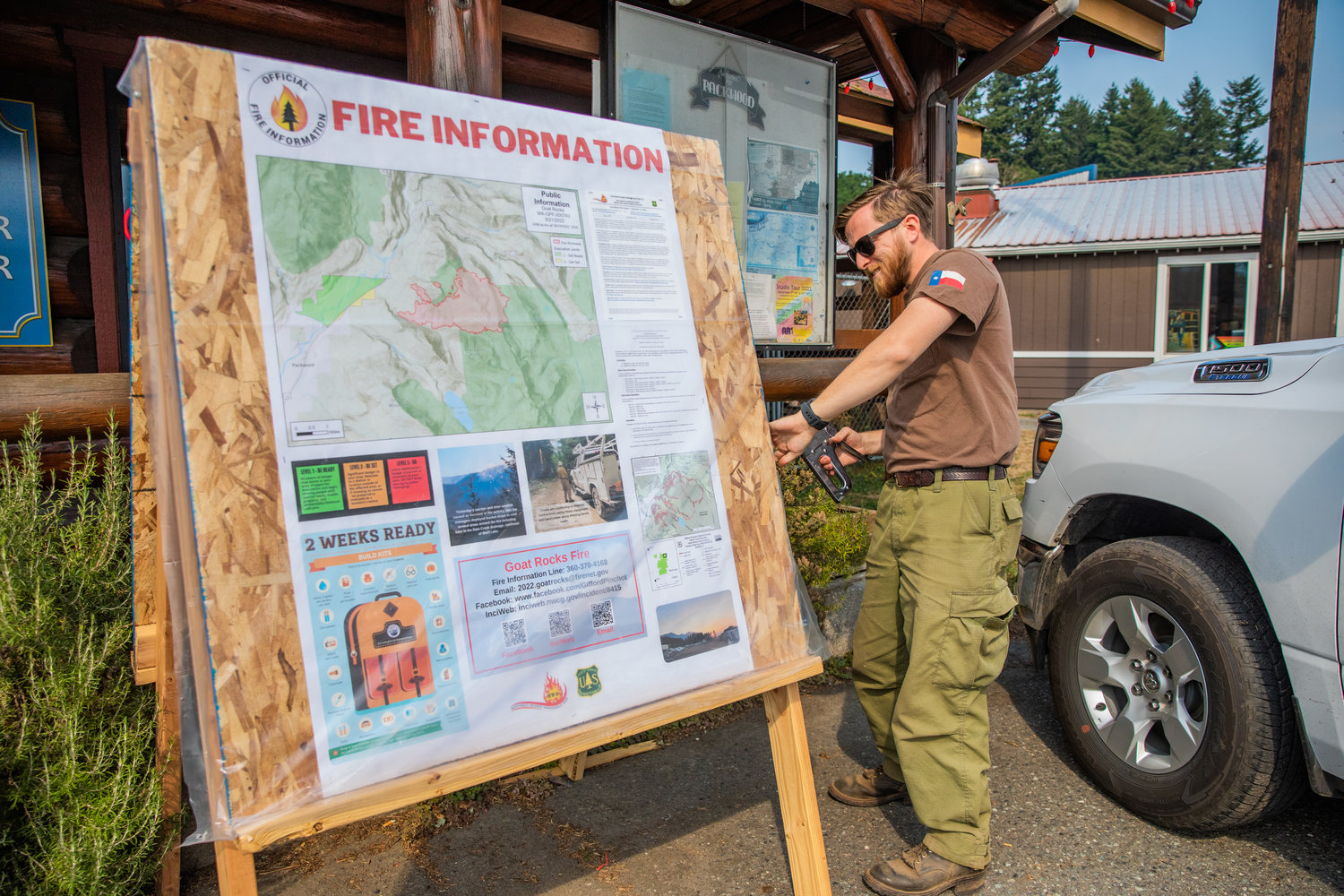 Adam Turner, with the U.S. Forest Service, posts fire information in Packwood on Wednesday with a map of the Goat Rocks Fire.