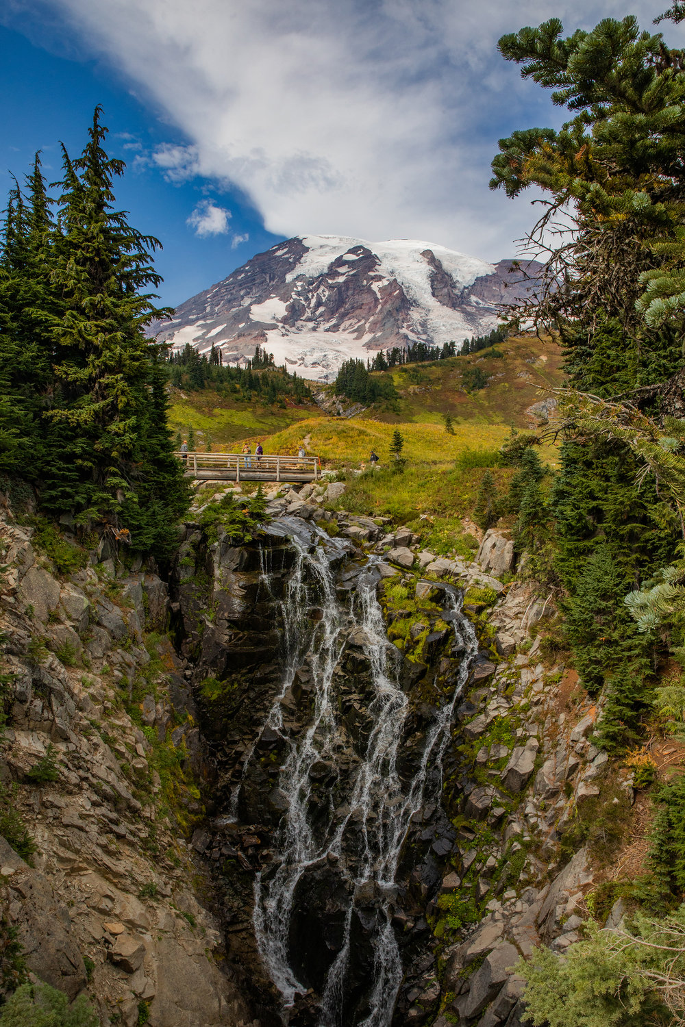 Mount Rainier sets the backdrop as water cascades down rocks at Myrtle Falls a quarter-mile from the Paradise parking lot on Wednesday near Ashford.