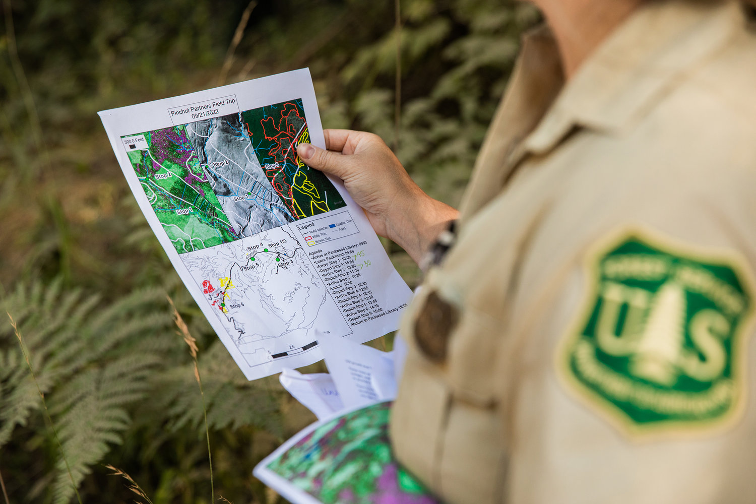 District Silviculturist Cheyenne Adamonis looks at maps during a Pinchot Partners Field Trip around Packwood on Wednesday.