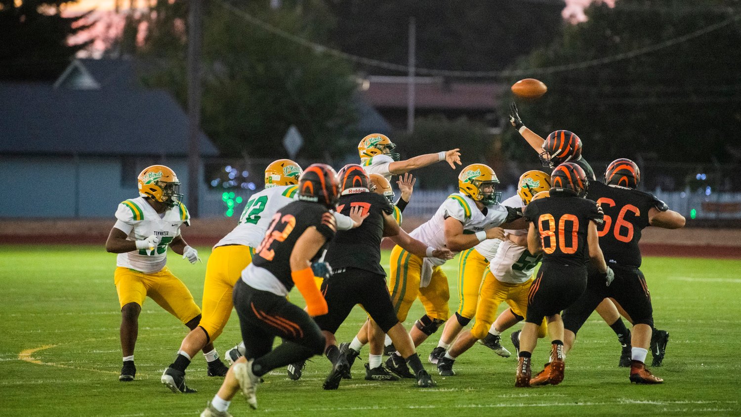Tumwater senior Alex Overbay (14) throws a pass over Centralia defenders Friday night.