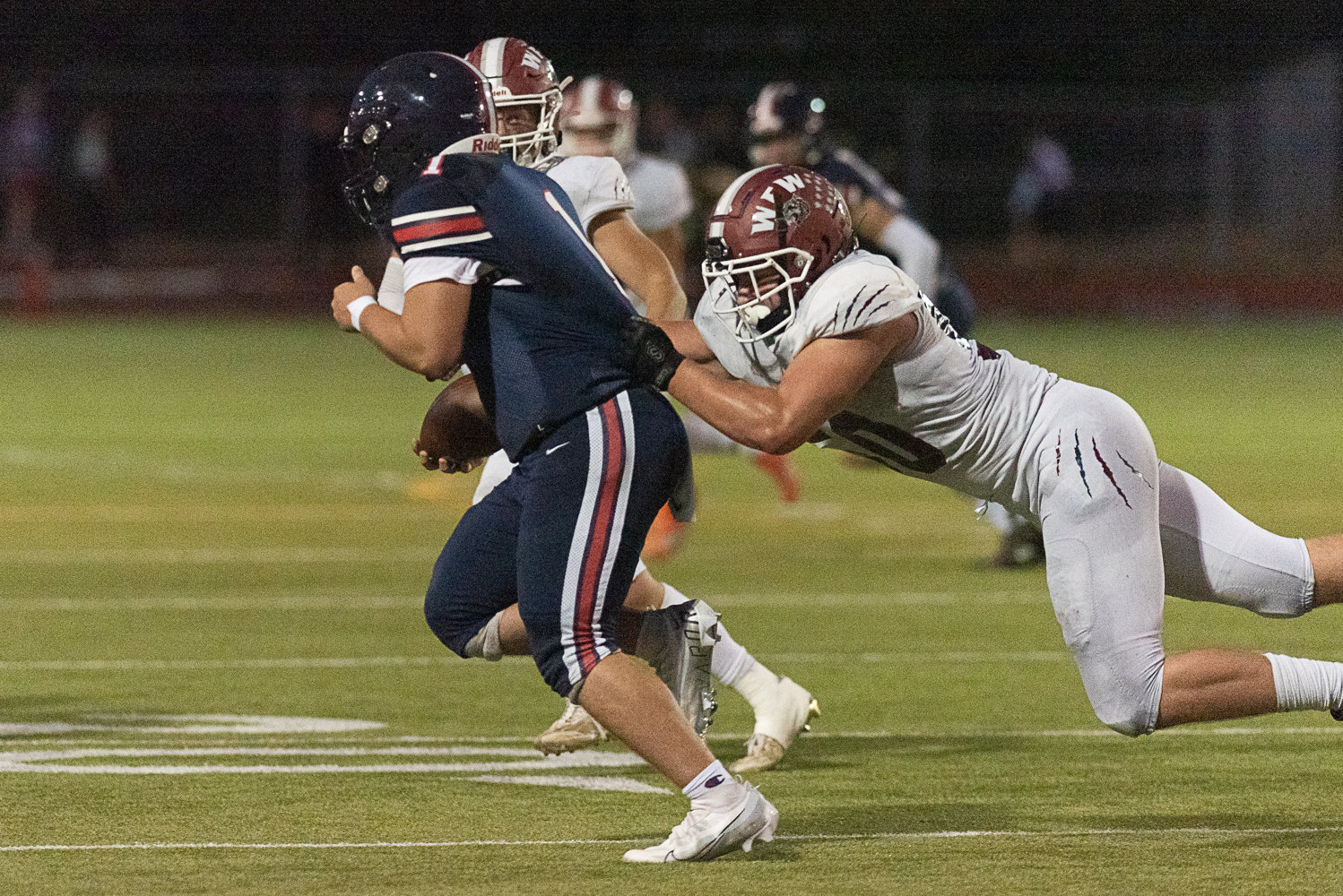 W.F. West defensive lineman William Buzzard flies in to sack Black Hills quarterback Jaxsen Beck during the Bearcats' 35-0 win over the Wolves at Tumwater District Stadium on Sept. 23.