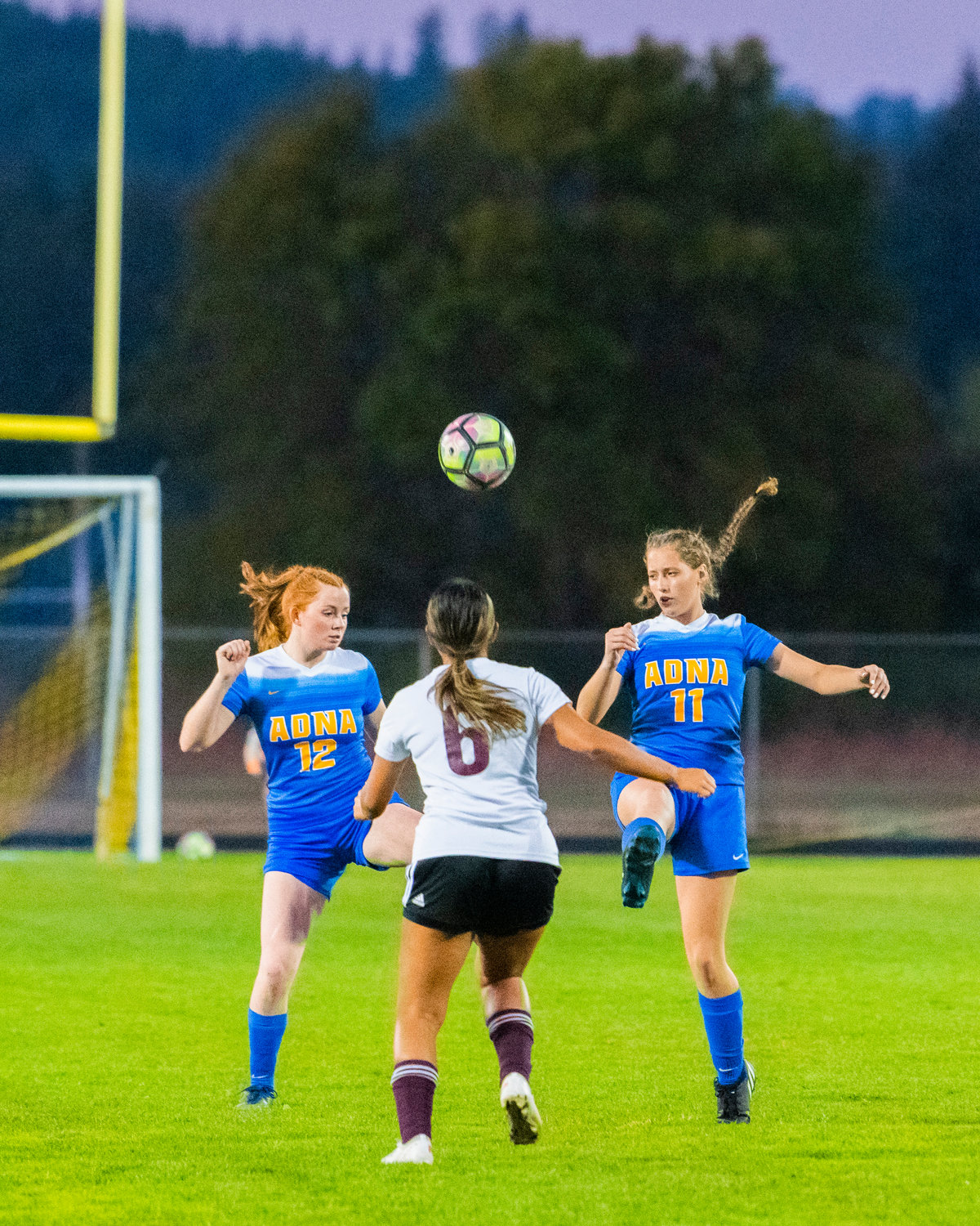 Adna’s Natalie Loose (12) and Bailey Naillon (11) control the ball Monday night at Pirate Stadium.