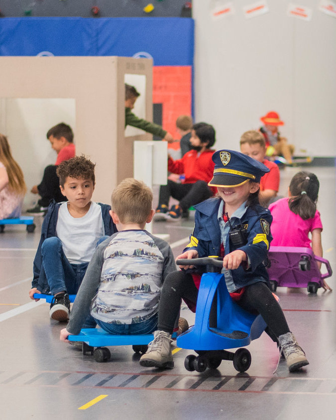 Students in Mrs. McVay and Mrs. Cole’s kindergarten classes ride scooters at James W. Lintott Elementary School in Chehalis last year.