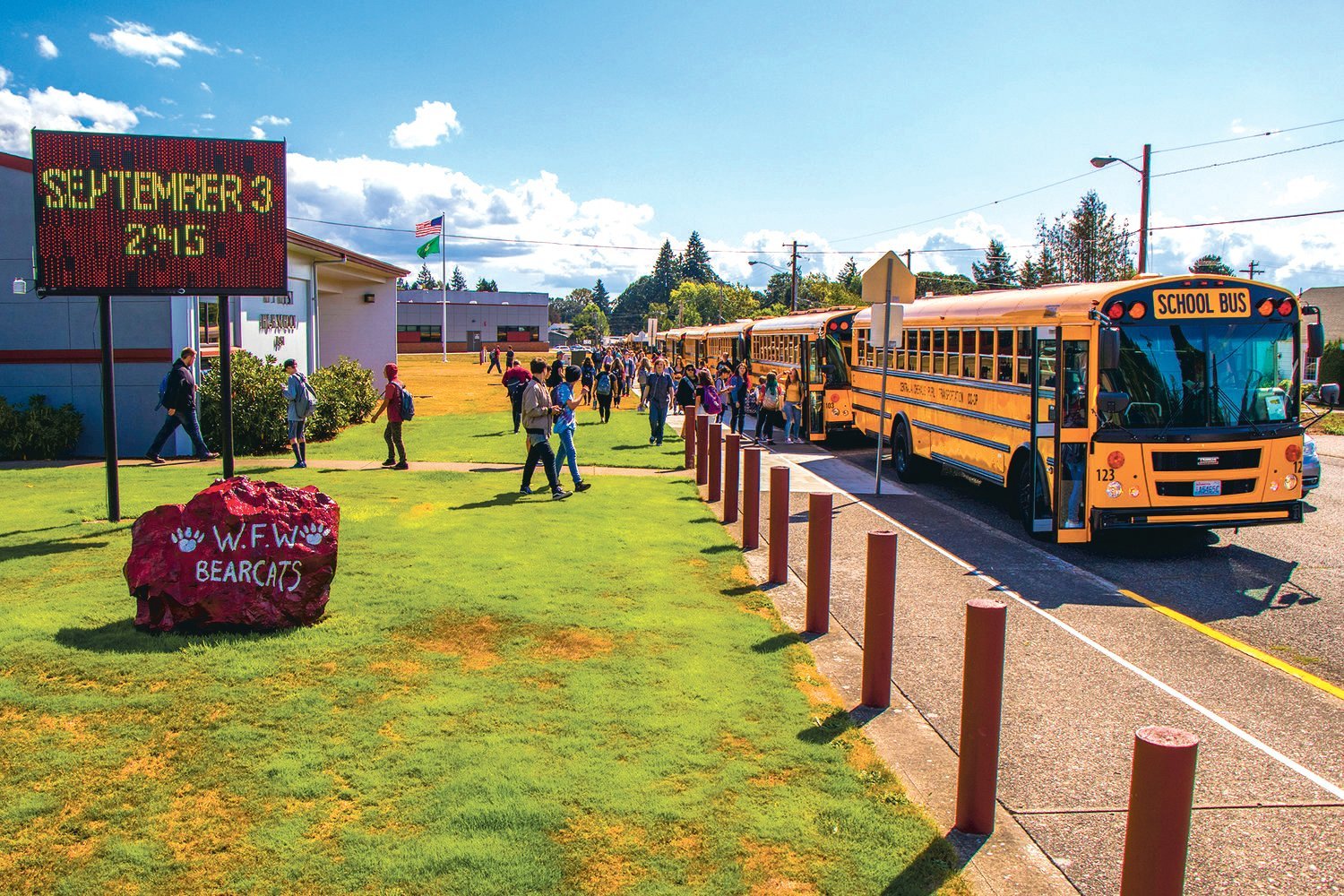 Students flood into buses at W.F. West High School as school is let out Tuesday afternoon in Chehalis.