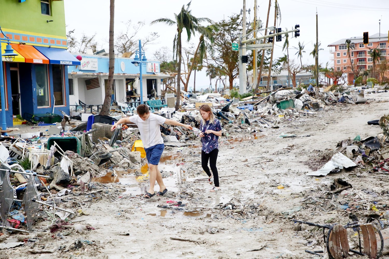 Jake Moses, 19, left, and Heather Jones, 18, of Fort Myers, explore a section of destroyed businesses at Fort Myers Beach on Thursday, Sep. 29, 2022. The community was mostly destroyed after Hurricane Ian made landfall on Wednesday. (Douglas R. Clifford/Tamps Bay Times/TNS)