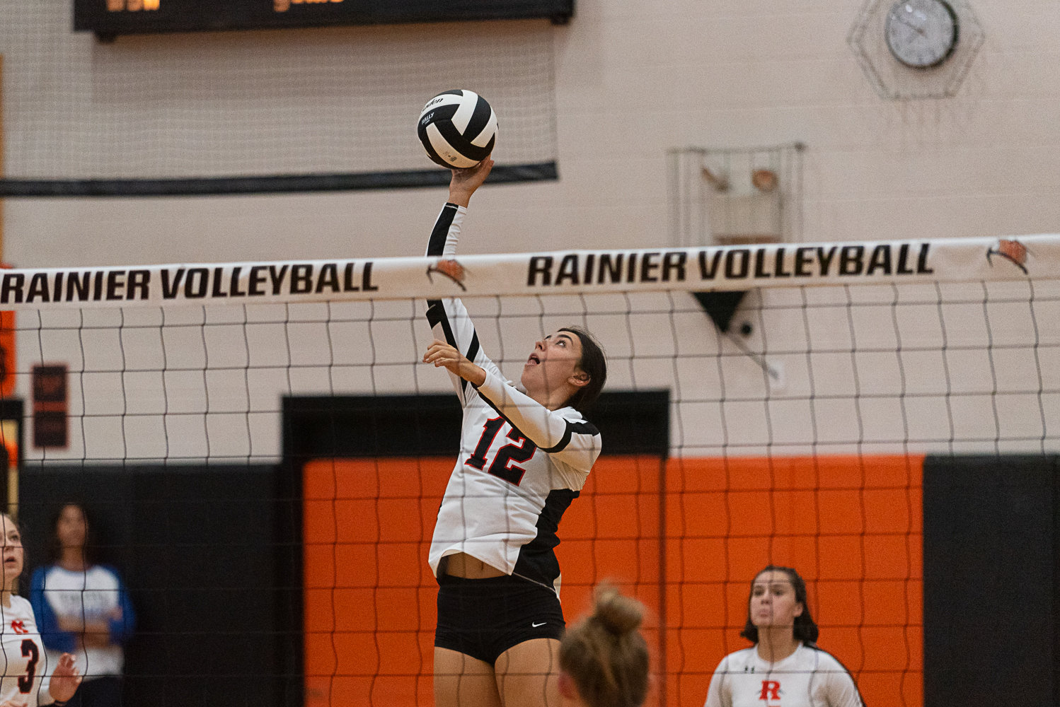 Acacia Murphy loops a tip over the net during Rainier's loss to Toutle Lake on Sept. 29.