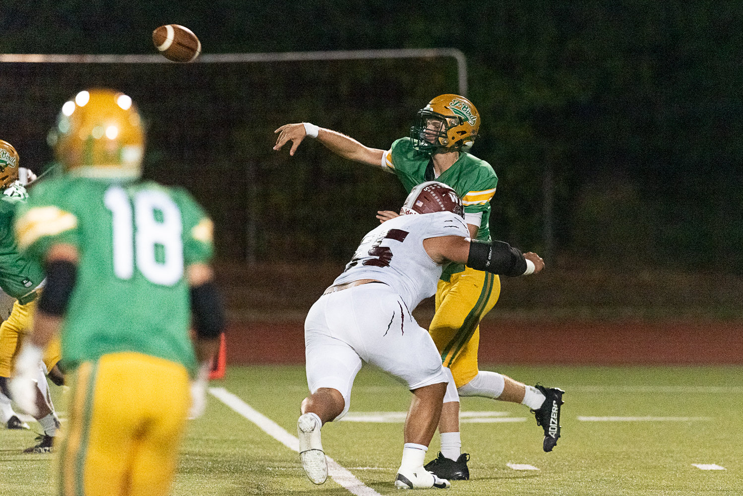 Daniel Matagi hits Tumwater quarterback Alex Overback hard as he releases the ball during W.F. West's 28-7 win over the T-Birds on Sept. 30.