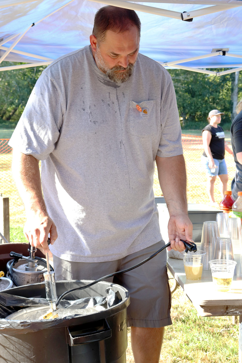 Paul Wilkenson serves beer from a keg at the Lewis-Pacific Swiss Society Oktoberfest in Frances on Saturday.