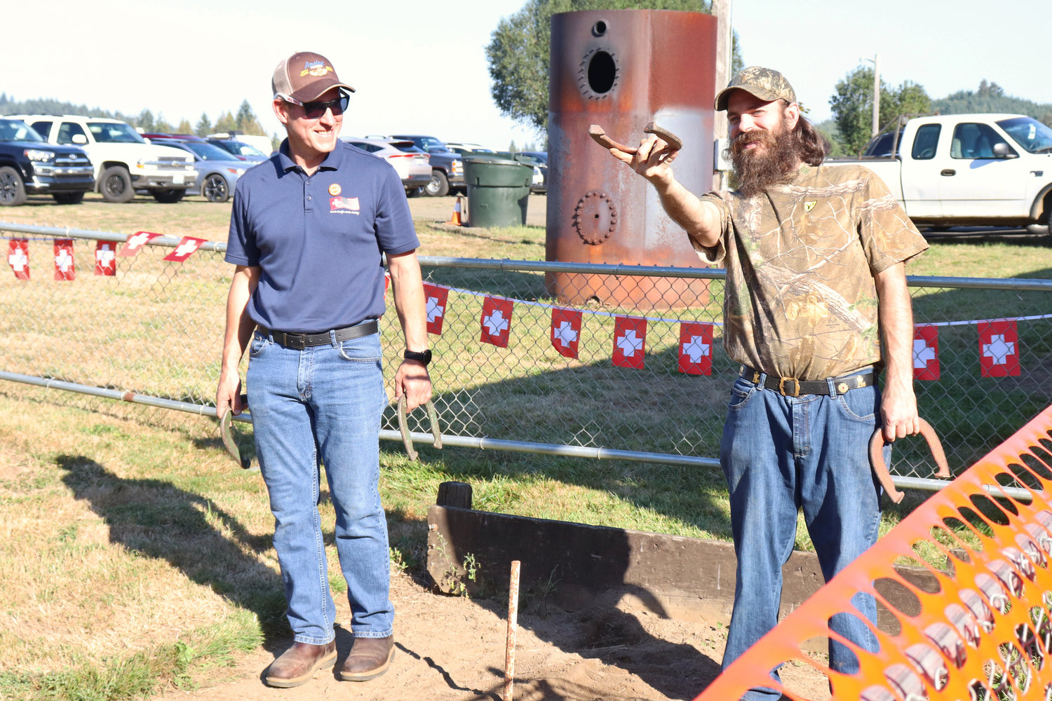 Alex Muller and Adrian Cook compete in a game of horseshoes during the Lewis-Pacific Swiss Society Oktoberfest in Frances on Saturday.
