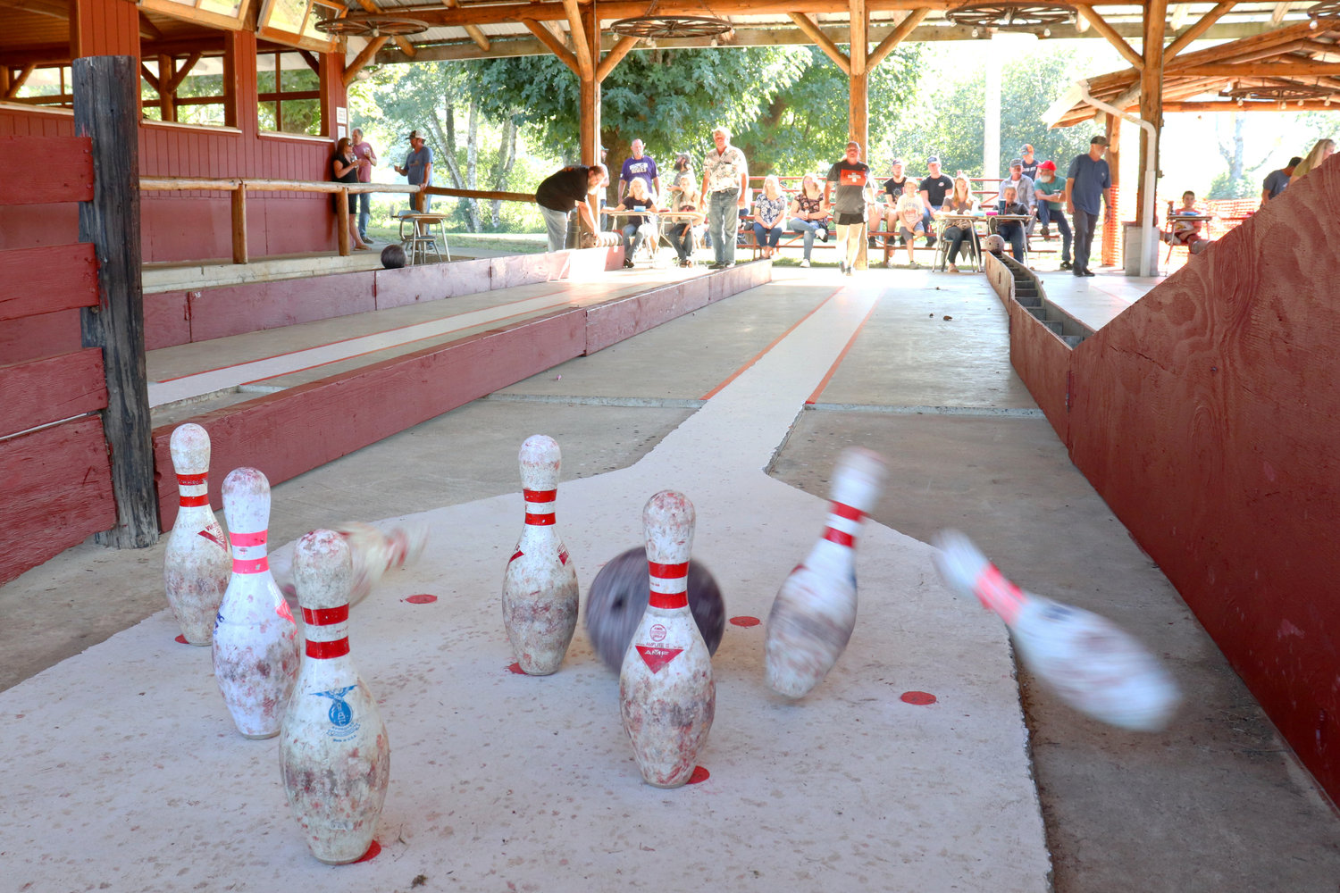 A bowling ball strikes pins during an outdoor European nine-pin bowling tournament held at the Lewis-Pacific Swiss Society Oktoberfest in Frances on Saturday. Cash prizes were on the line for the top bowlers, with the first perfect score of the day winning $500.