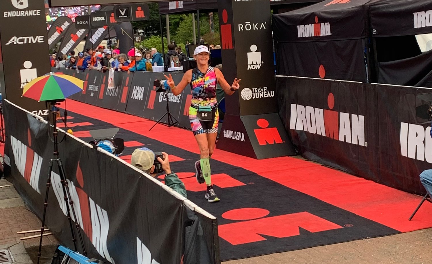 Linda Johnson crosses the finish line during the Alaska Ironman 2022 to qualify for the World Championships in Kona, Hawaii.