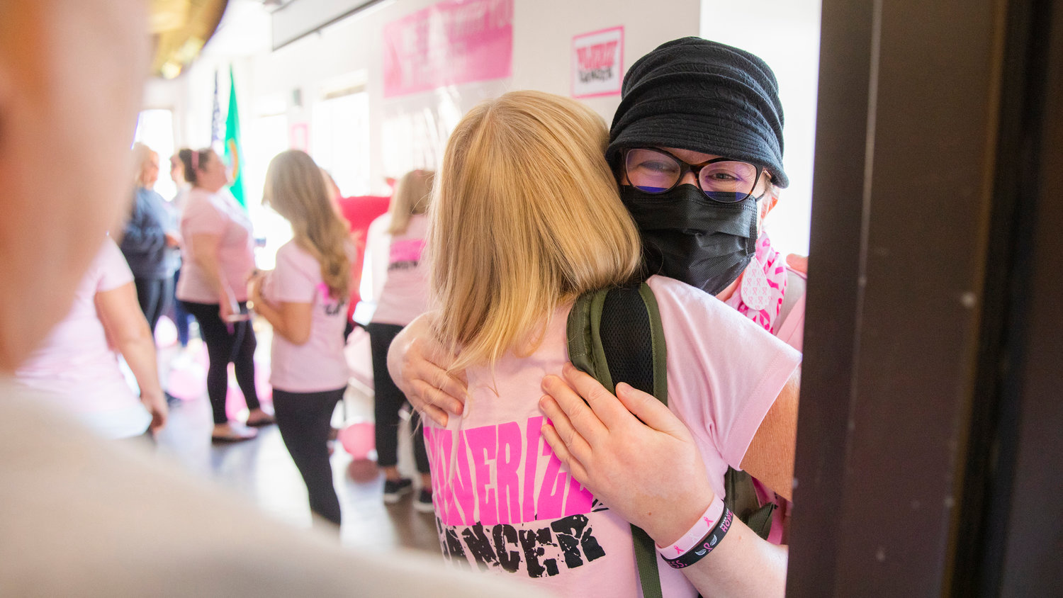 Lori Pulver receives an embrace Friday morning in Chehalis. Pulver has been in an ongoing fight with breast cancer. The phrase “Pulver-ize Cancer” has been displayed in windows outside the Lewis County Courthouse this month.