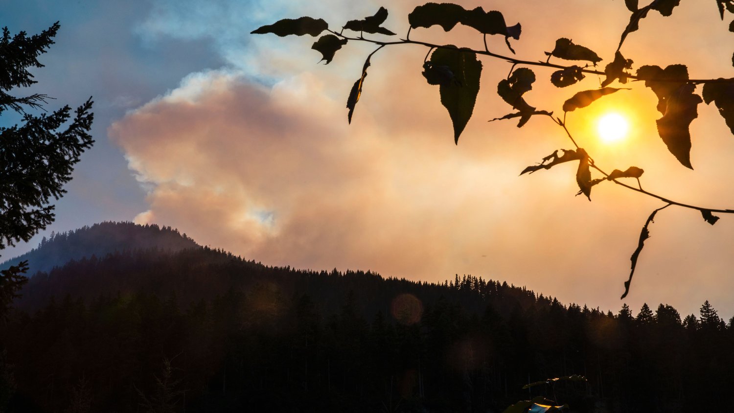 The sun shines through smoke from the Goat Rocks Fire on Sunday as seen from the Palisades Viewpoint off U.S. Highway 12 near Packwood Sunday.