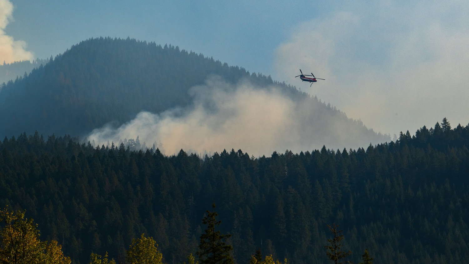 A helicopter is used to dump water on the Goat Rocks Fire Sunday.