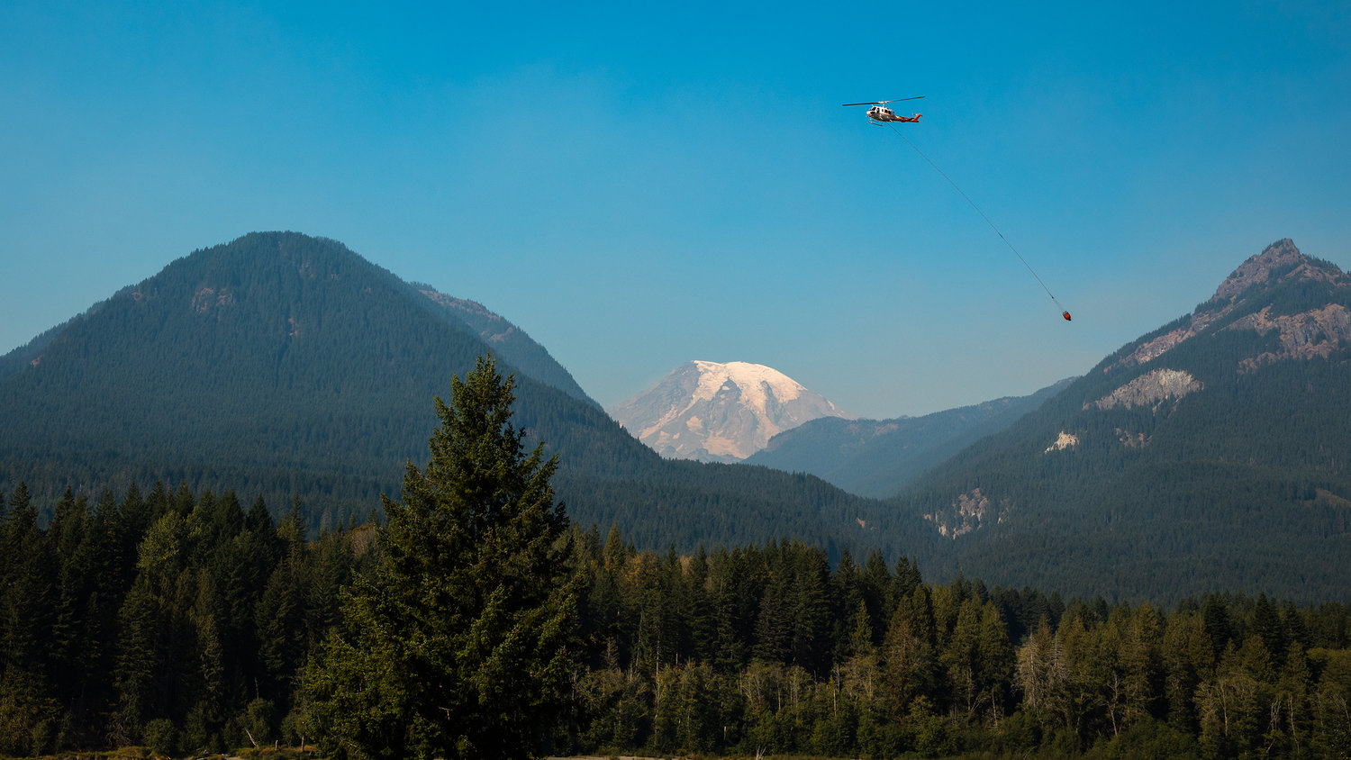 A helicopter is used to dump water on the Goat Rocks Fire Sunday.