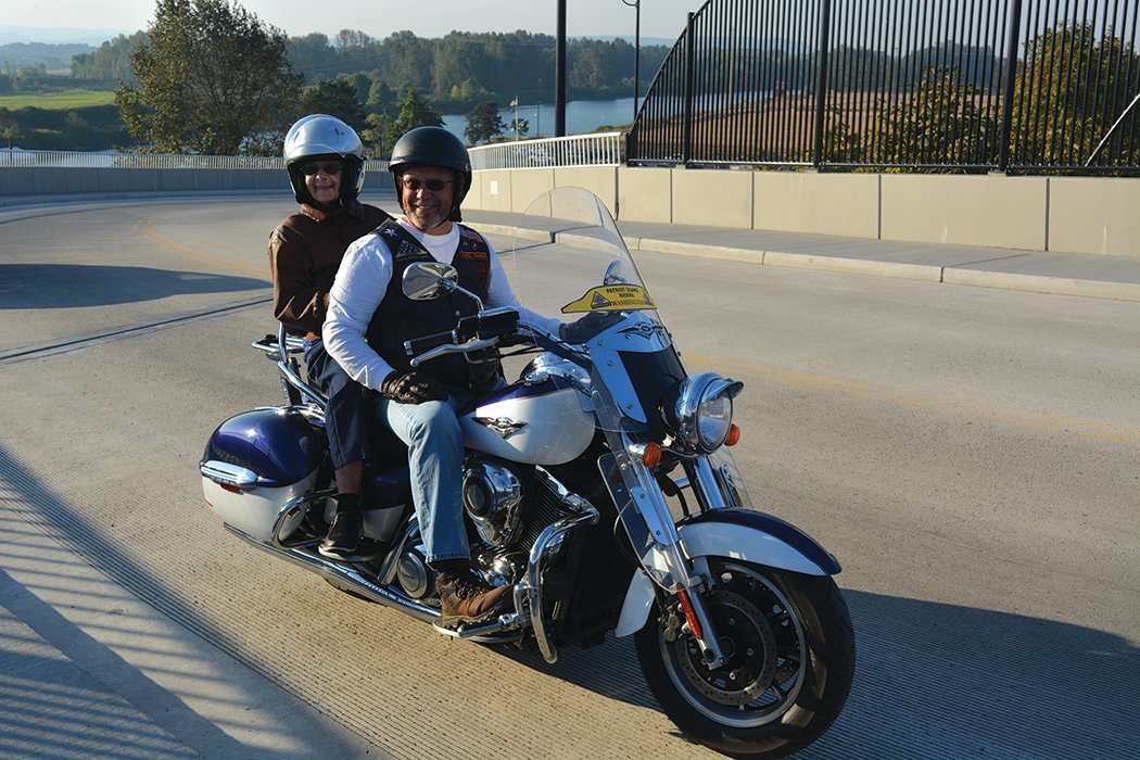 Delores Hawkins sits behind Dave Boyce on a motorcycle in Ridgefield on Oct. 6.