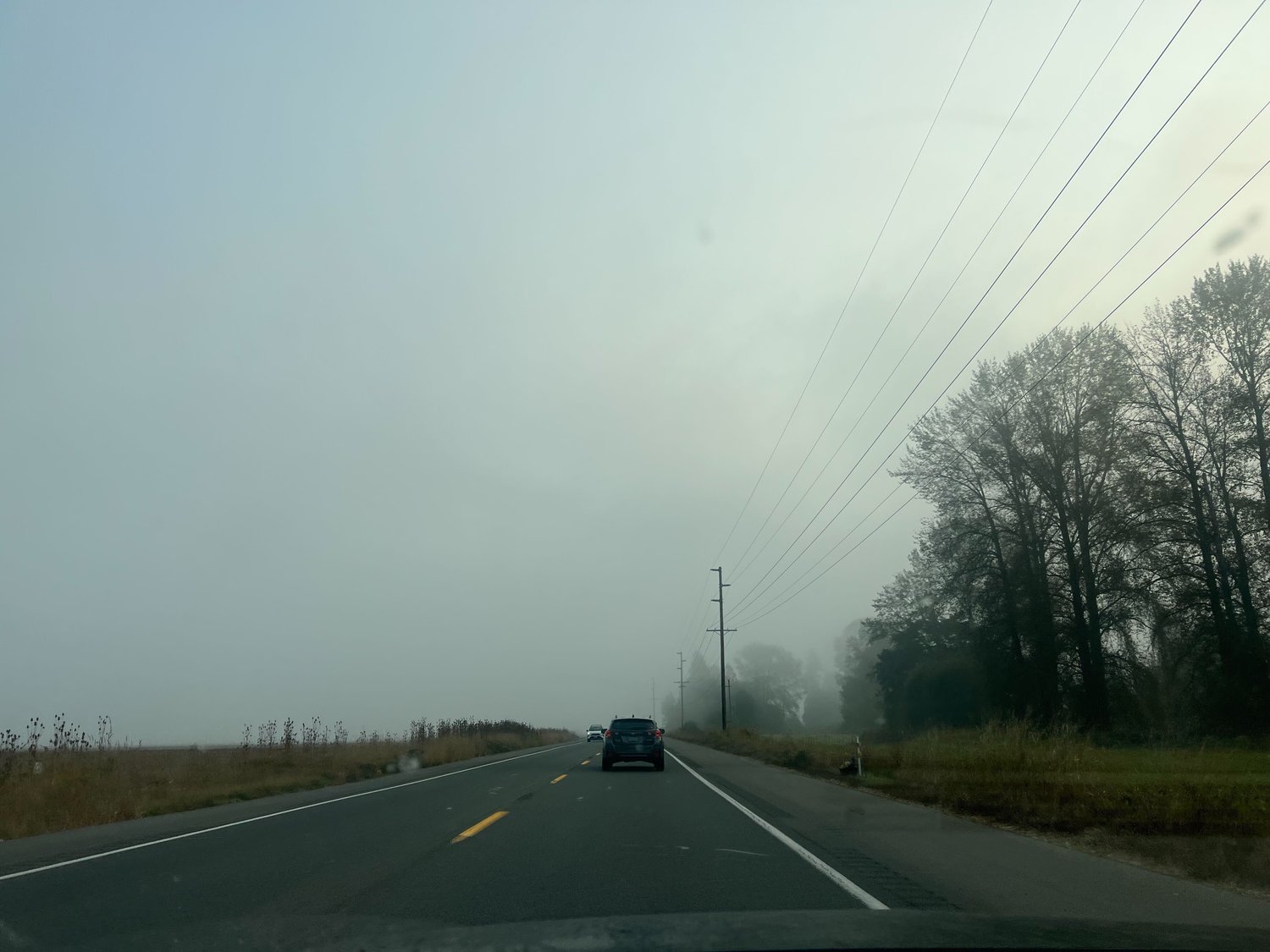 Morning fog settles underneath wildfire smoke in Chehalis on Wednesday morning, causing whiteout conditions.