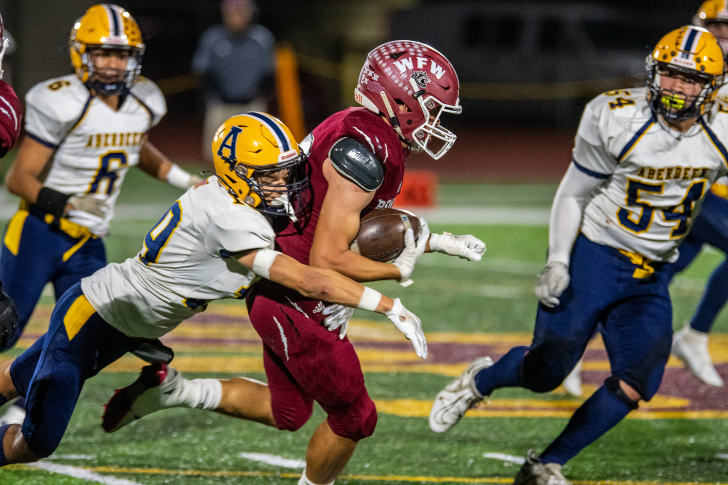 W.F. West's Declan McDonald fights off an Aberdeen defender on a punt return during a game at South Bend High School on Oct. 20.