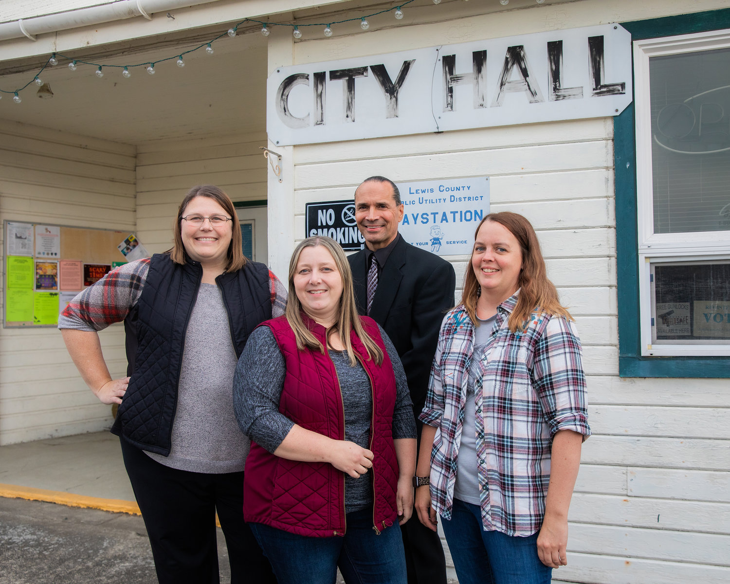 From left, Clerk Assistant Shelly Allen, City Treasurer Jill Davis, Police Chief Duane Garvais Lawrence and Police Department City Clerk Deavon Jacobson smile and pose for a photo outside Toledo City Hall on Thursday.