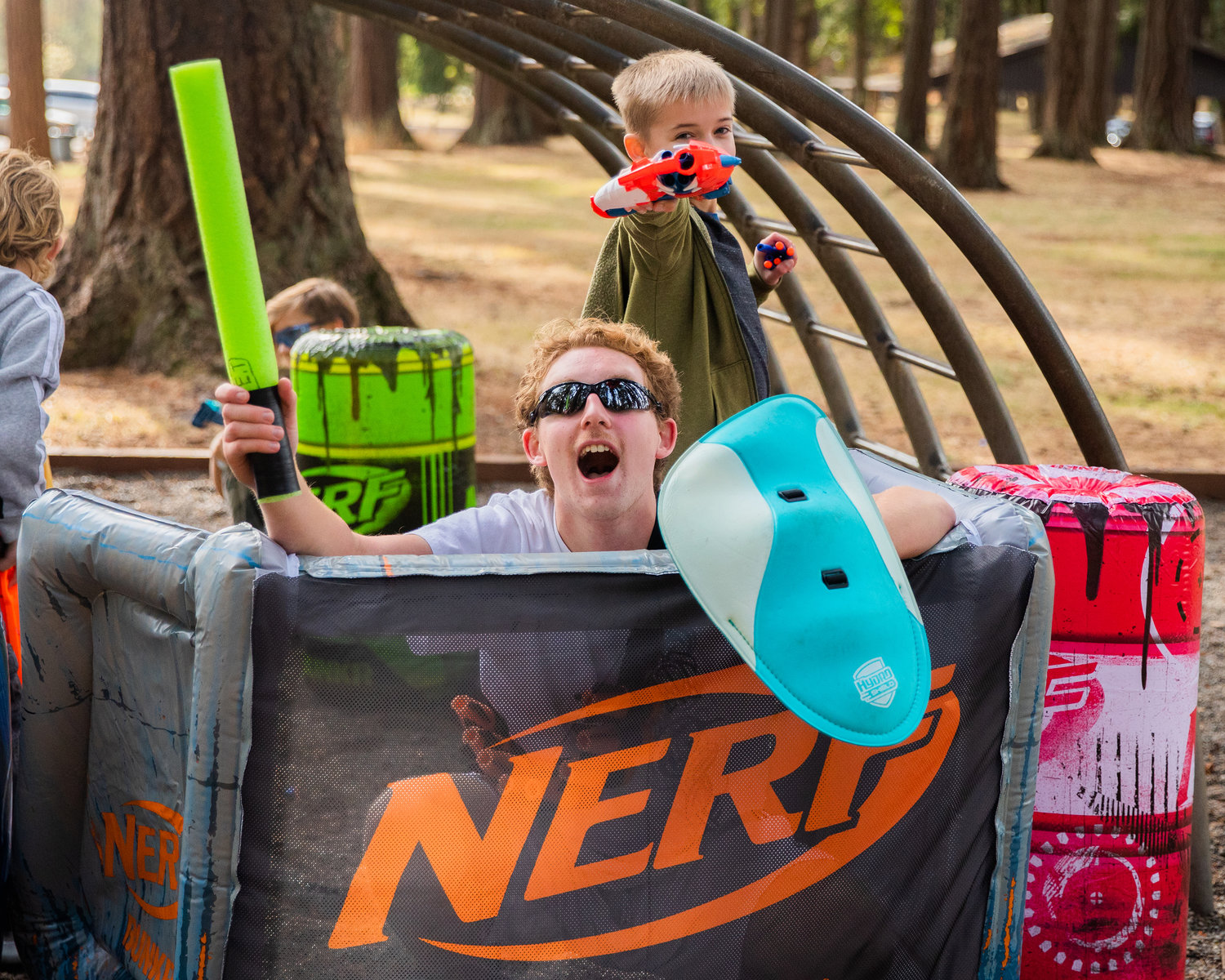 Nerf blasters and foam swords are held up in battle at Borst Park on Sunday.