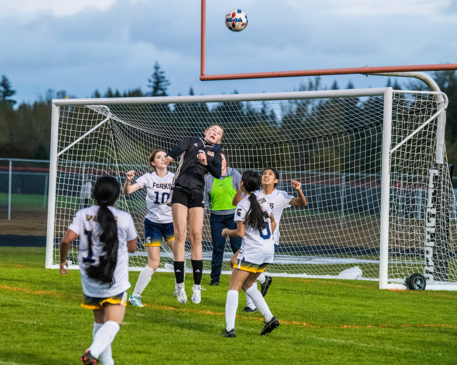 Napavine freshman Hayden Kaut (3) makes a header towards the goal Monday night at Tiger Field during a game against Forks.