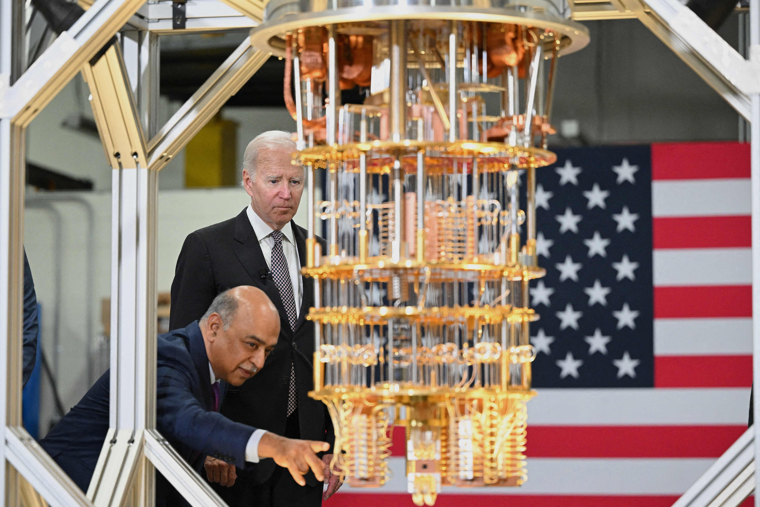 U.S. President Joe Biden listens to IBM CEO Arvind Krishna as he tours the IBM facility in Poughkeepsie, New York, on October 6, 2022. - IBM's CEO Arvind Krishna announced Thursday a $20-billion investment in quantum computing, semiconductor manufacturing, and other high-tech areas in its New York state facilities. (MANDEL NGAN/AFP via Getty Images/TNS)
