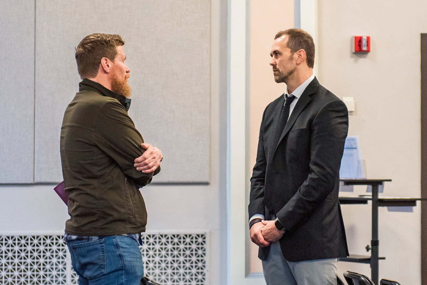 Commissioner Sean Swope approaches Cole Meckle, pastor at Gather Church in Centralia — which has run the county’s coordinated entry program among other services for homelessness — ahead of Tuesday morning meetings in the Lewis County Commissioners’ Hearing room in Chehalis.