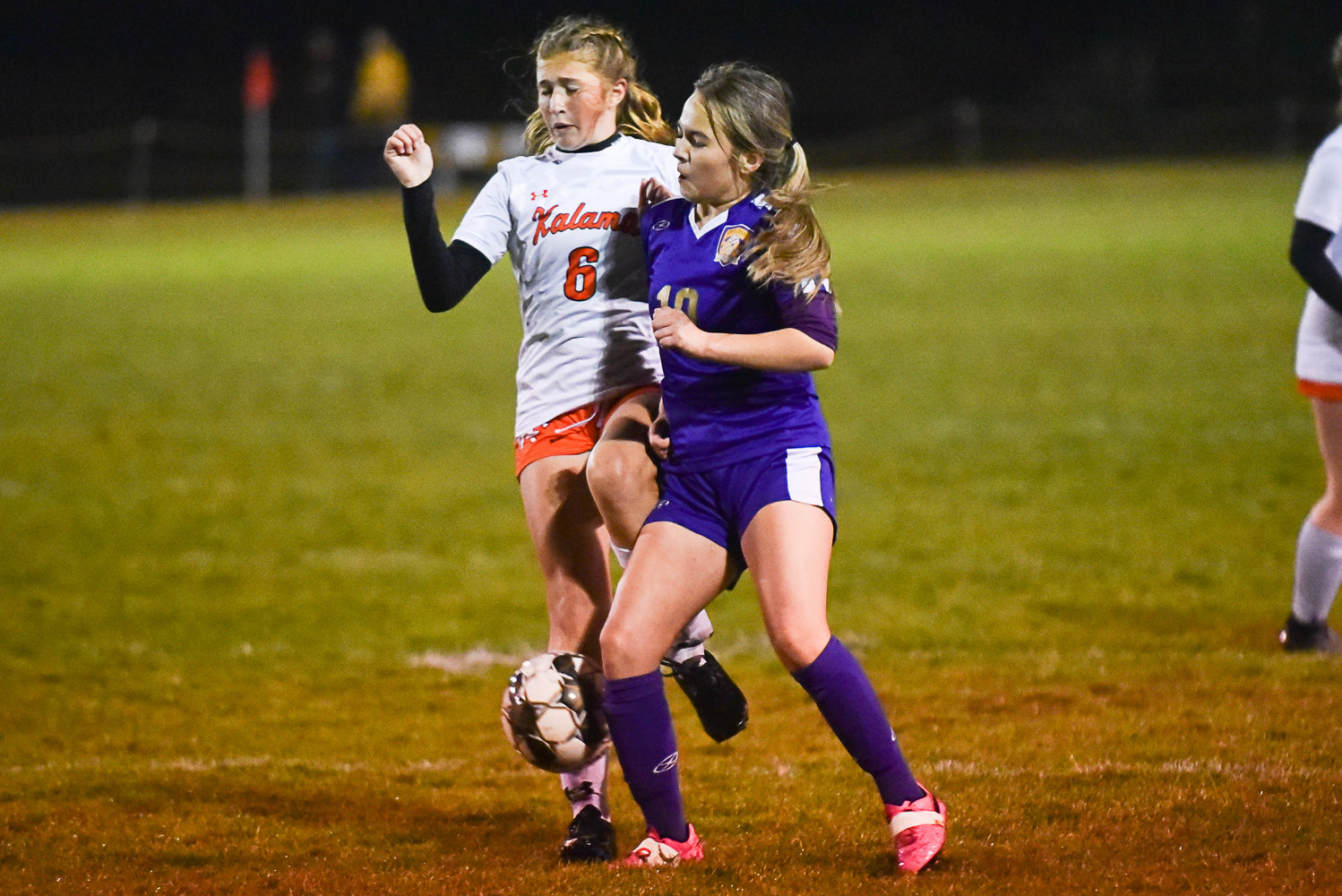Onalaska's Yuliana Escalara wins a shoulder-to-shoulder battle with Kalama's Elly Foreman during the Chinooks' 6-0 win over the Loggers on Oct. 26.