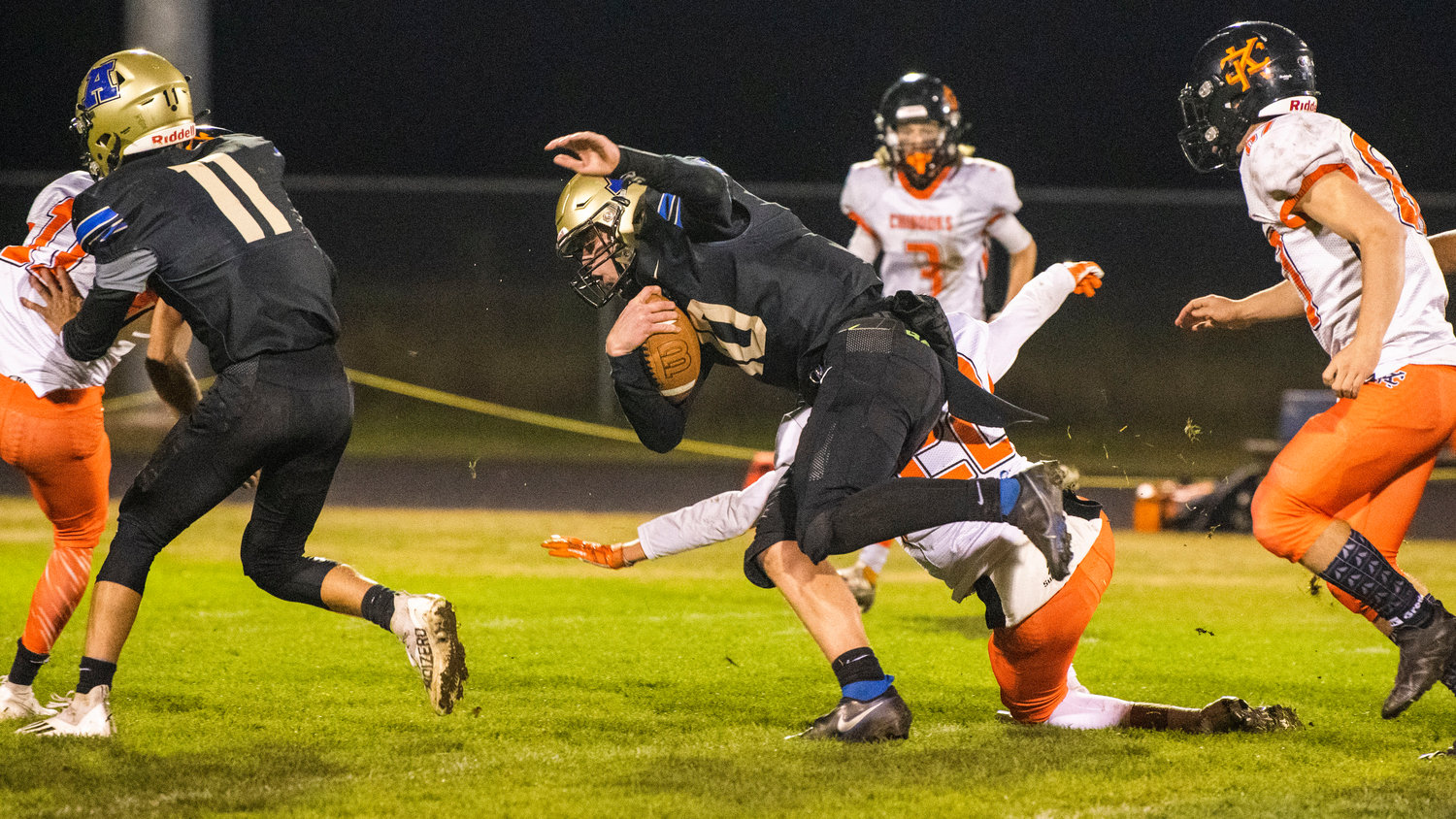 Adna quarterback Lane Johnson (10) lcrashes through Kalama defenders while running with the football during a Thursday night game at Pirate Stadium.