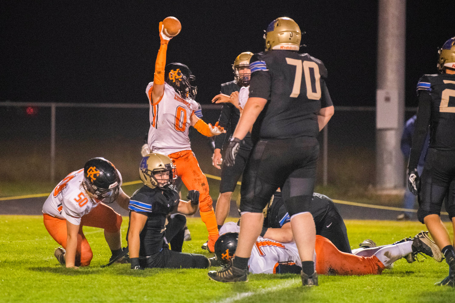 Kalama junior Hayden Lawson (0) comes up with the ball after a fumble during a game Thursday night in Adna.