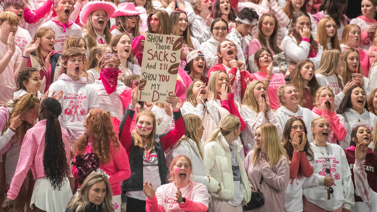 Bearcat fans cheer and hold signs during a game against Centralia on Friday.
